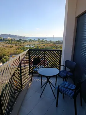 a balcony with a table and chairs and the ocean at Harmony in Bar
