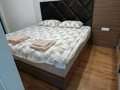 a bed with two pillows on it in a room at Harmony in Bar