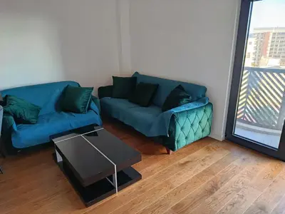 a living room with two blue couches and a table at Harmony in Bar