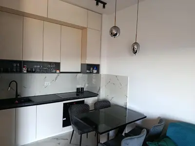 a kitchen with a glass table and chairs at Harmony in Bar
