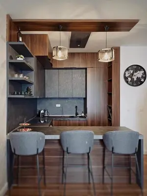 a kitchen with a counter with chairs and a sink at Apartman Bulevar in Ulcinj