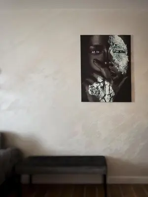 a black and white picture of a woman on a wall at Apartman Bulevar in Ulcinj