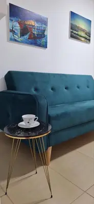 a blue couch and a table with a bowl on it at Montebello Inn apartments in Ulcinj