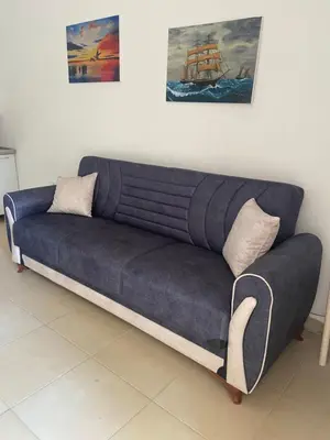 a blue couch sitting in a living room at Montebello Inn apartments in Ulcinj