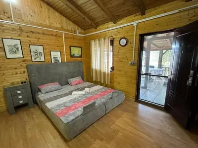 a bedroom with a bed in a wooden room at Sojenica Asije in Ulcinj