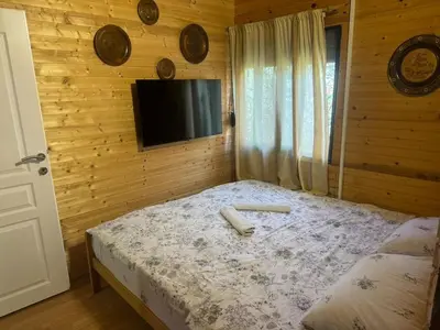 a bedroom with a bed with a tv on the wall at Sojenica Asije in Ulcinj