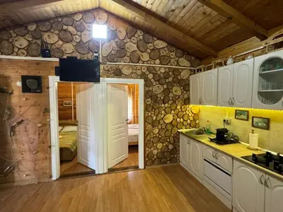 a kitchen with white cabinets and a room with a bedroom at Sojenica Asije in Ulcinj