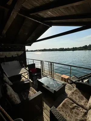 a deck of a boat with a table and chairs at Sojenica Asije in Ulcinj