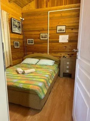 a bedroom with a bed in a room with wooden walls at Sojenica Asije in Ulcinj