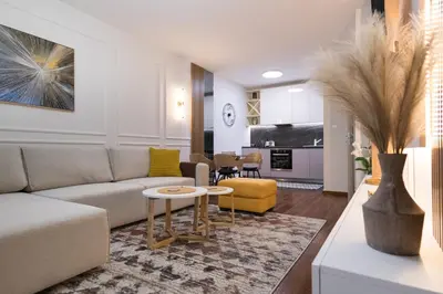 a living room with a couch and a table at A&T Lux in Podgorica
