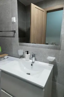 a bathroom with a white sink and a mirror at A&T Lux in Podgorica
