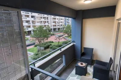 a room with a balcony with a view of a city at A&T Lux in Podgorica