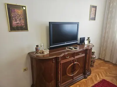 a flat screen tv sitting on top of a wooden cabinet at Apartment K8 Center in Podgorica