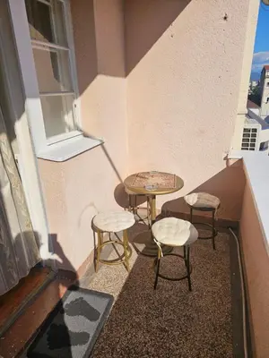 a balcony with two tables and two stools and a table at Apartment K8 Center in Podgorica