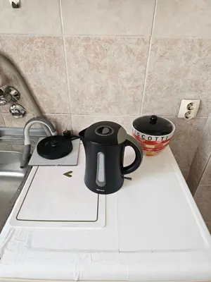a black coffee mug sitting on top of a kitchen counter at Apartment K8 Center in Podgorica