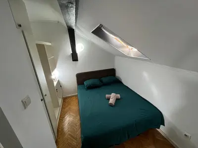 a small bedroom with a teddy bear on a bed at Downtown Nest Podgorica in Podgorica