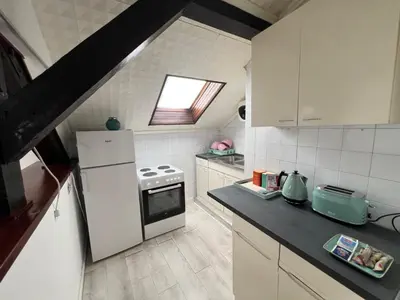 a kitchen with a white refrigerator and a stove at Downtown Nest Podgorica in Podgorica