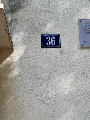 a blue sign on the side of a building at Downtown Nest Podgorica in Podgorica