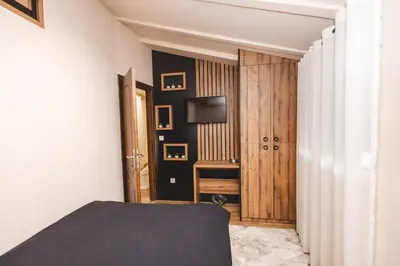 a bedroom with a bed and a television on a wall at Stara Varos in Podgorica