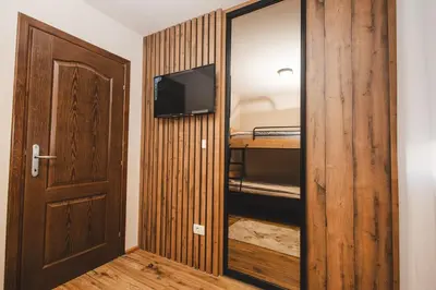 a room with a closet with a television and a door at Stara Varos in Podgorica