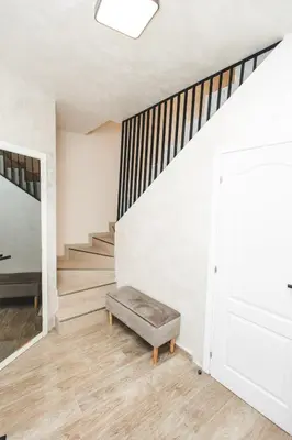a staircase with a bench in a room with white walls at Stara Varos in Podgorica