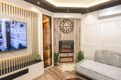 a living room with a tv and a fireplace at Stara Varos in Podgorica