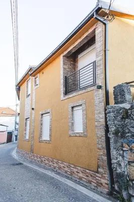 a brick building with a balcony on the side of it at Stara Varos in Podgorica