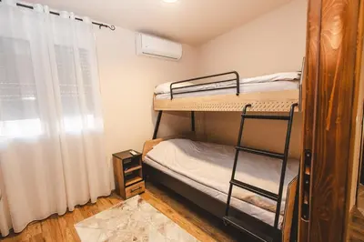a room with two bunk beds and a window at Stara Varos in Podgorica