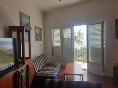 a living room with a couch and a tv at Ana in Becici