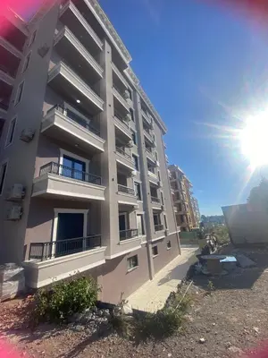a tall apartment building with the sun in the background at Apartman Sabi in Bar