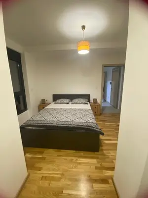 a bedroom with a bed in the middle of a room at Apartman Sabi in Bar