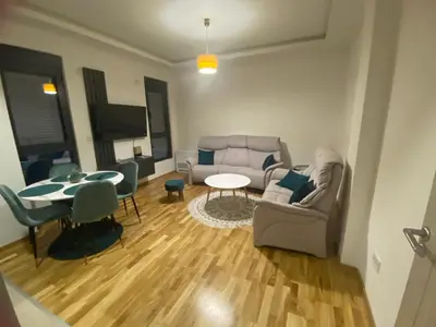a living room with a couch and a table at Apartman Sabi in Bar