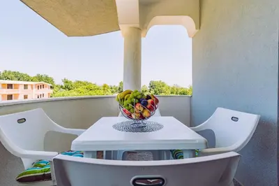 a bowl of fruit on a table on a balcony at Biševo Apartmani in Donji Štoj