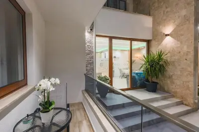 a staircase in a house with a glass table at APART-HOTEL PRESiDENT 2 in Ulcinj
