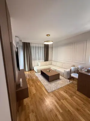 a living room with a couch and a table at Diamond H in Podgorica
