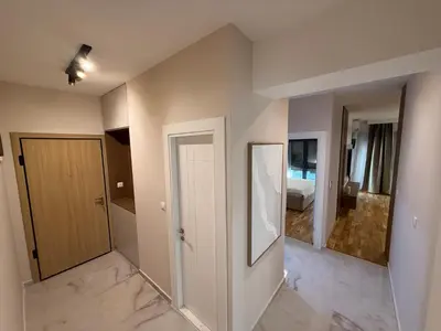an empty room with a door and a bedroom at Diamond H in Podgorica