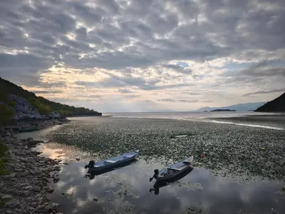 two boats are sitting in the water on the beach at Pelican Bay House - Skadar Lake in Krnjice