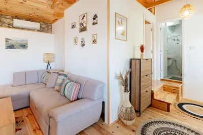 a living room with a couch and a table at Pelican Bay House - Skadar Lake in Krnjice