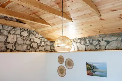 a chandelier hanging from the ceiling of a room at Pelican Bay House - Skadar Lake in Krnjice