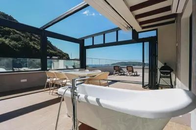 a bath tub on the balcony of a house at Penthouse with Sea view Rafailovici in Budva