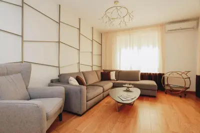 a living room with a couch and a table at Penthouse with Sea view Rafailovici in Budva