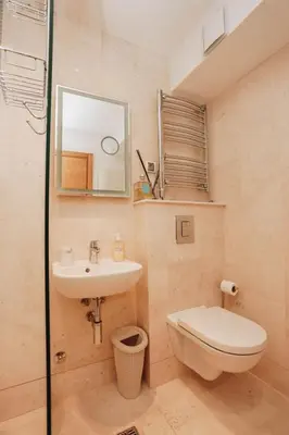 a bathroom with a sink and a toilet and a mirror at Penthouse with Sea view Rafailovici in Budva