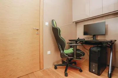 an office with a desk with a computer and a chair at Penthouse with Sea view Rafailovici in Budva