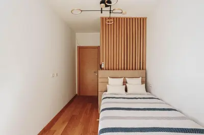 a small room with two beds in it at Penthouse with Sea view Rafailovici in Budva