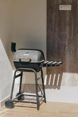 a grill sitting on a table in a room at Penthouse with Sea view Rafailovici in Budva