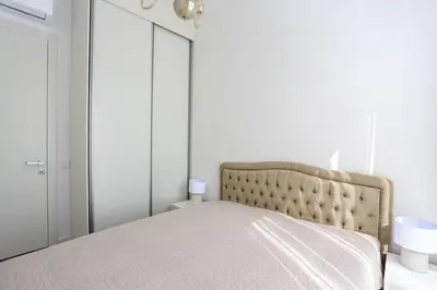 a bedroom with a bed and a mirror at Luxury Horizon Penthouse Budva in Becici