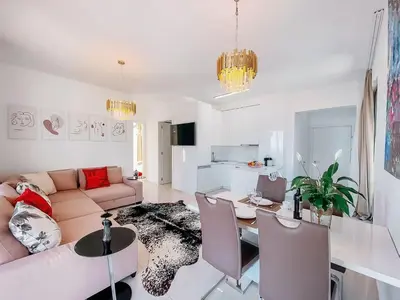 a living room with a couch and a table at Luxury Horizon Penthouse Budva in Becici