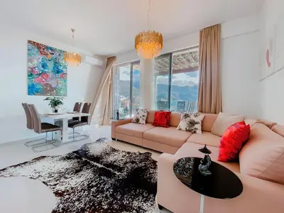 a living room with a couch and a table at Luxury Horizon Penthouse Budva in Becici