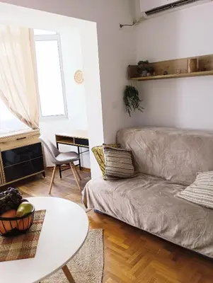 a living room with a couch and a table at Ardea apart in Budva