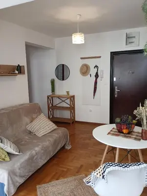 a living room with a couch and a table at Ardea apart in Budva